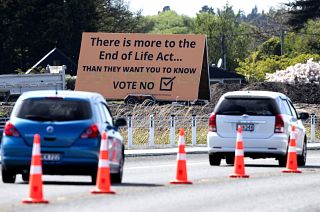 In this Oct. 16, 2020, file photo, cars are driven past a billboard urging voters to vote "No" against euthanasia in Christchurch, New Zealand