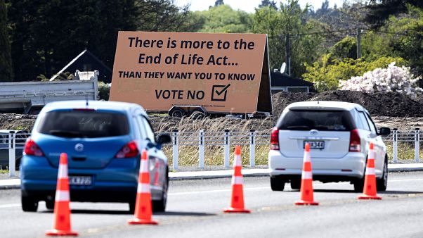 In this Oct. 16, 2020, file photo, cars are driven past a billboard urging voters to vote "No" against euthanasia in Christchurch, New Zealand In this Oct. 16, 2020, file photo, cars are driven past a billboard urging voters to vote "No" against euthanasia in Christchurch, New Zealand
