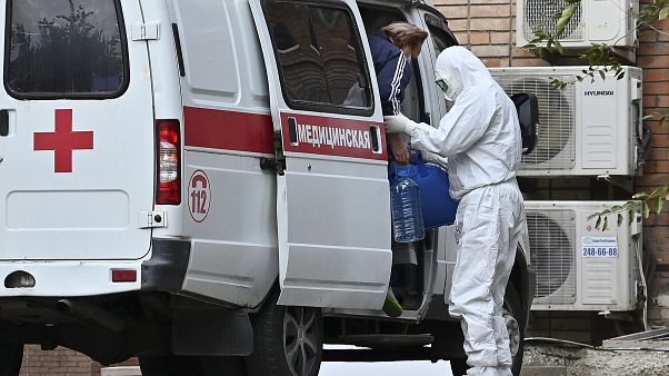 Пациента с подозрением на COVID-19 забирает машина скорой помощи Пациента с подозрением на COVID-19 забирает машина скорой помощи
