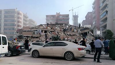 People work on a collapsed building, in Izmir, Turkey, Friday, Oct. 30, 2020, after a strong earthquake in the Aegean Sea