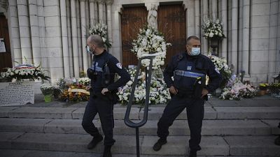 Municipal policemen stand guard outside Notre Dame church in Nice, France