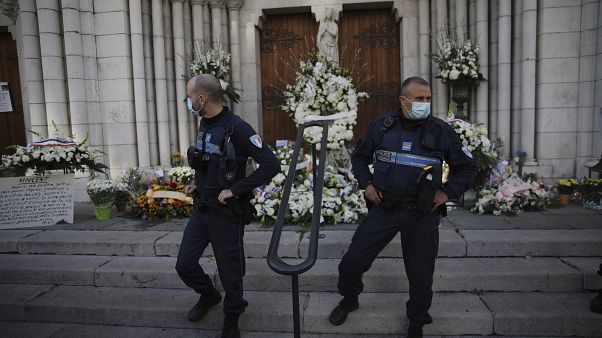 Municipal policemen stand guard outside Notre Dame church in Nice, France Municipal policemen stand guard outside Notre Dame church in Nice, France