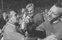 FILE - In this July 30, 1966 file photo, Nobby Stiles, right, looks at the Jules Rimet Cup, held by England captain Bobby Moore after they had won the trophy