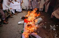 Supporters of Islami Oikya Jote, an Islamist political party, burn an effigy representing French President Emmanuel Macron during a protest in Dhaka, Bangladesh