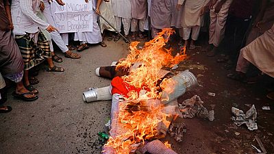 Supporters of Islami Oikya Jote, an Islamist political party, burn an effigy representing French President Emmanuel Macron during a protest in Dhaka, Bangladesh