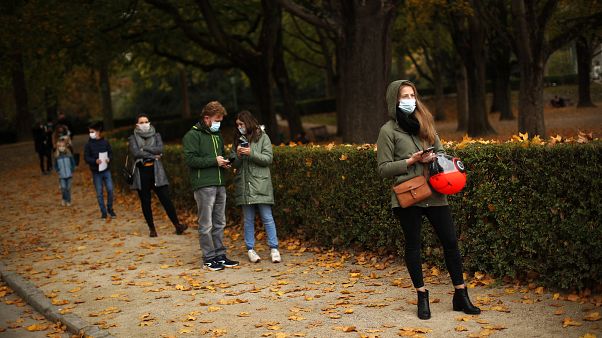 People observing social distancing wait in line to be tested in a Red Cross COVID-19 test centre at Cinquantenaire park in Brussels. Monday, Oct. 19, 2020.