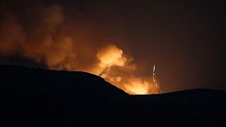 Explosions behind the mountains during a military conflict outside Stepanakert