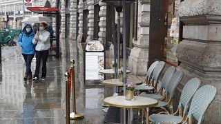 People wearing masks to help prevent the spread of the coronavirus walk along Regent Street, one of the main shopping streets in London, Thursday, Oct. 29, 2020.