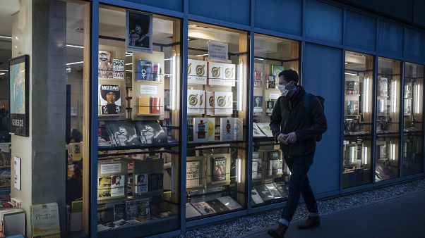 A masked man walks by a bookstore in Paris, Thursday October 29, 2020. A masked man walks by a bookstore in Paris, Thursday October 29, 2020.