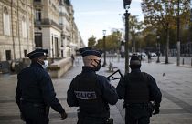 FILE - Police officers patrolling on the Champs Elysees avenue in Paris last month.