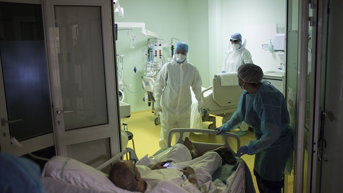 A medical crew receive a COVID-19 patient into the intensive care unit at the Joseph Imbert Hospital Center in Arles, southern France, Wednesday, Oct. 28, 2020