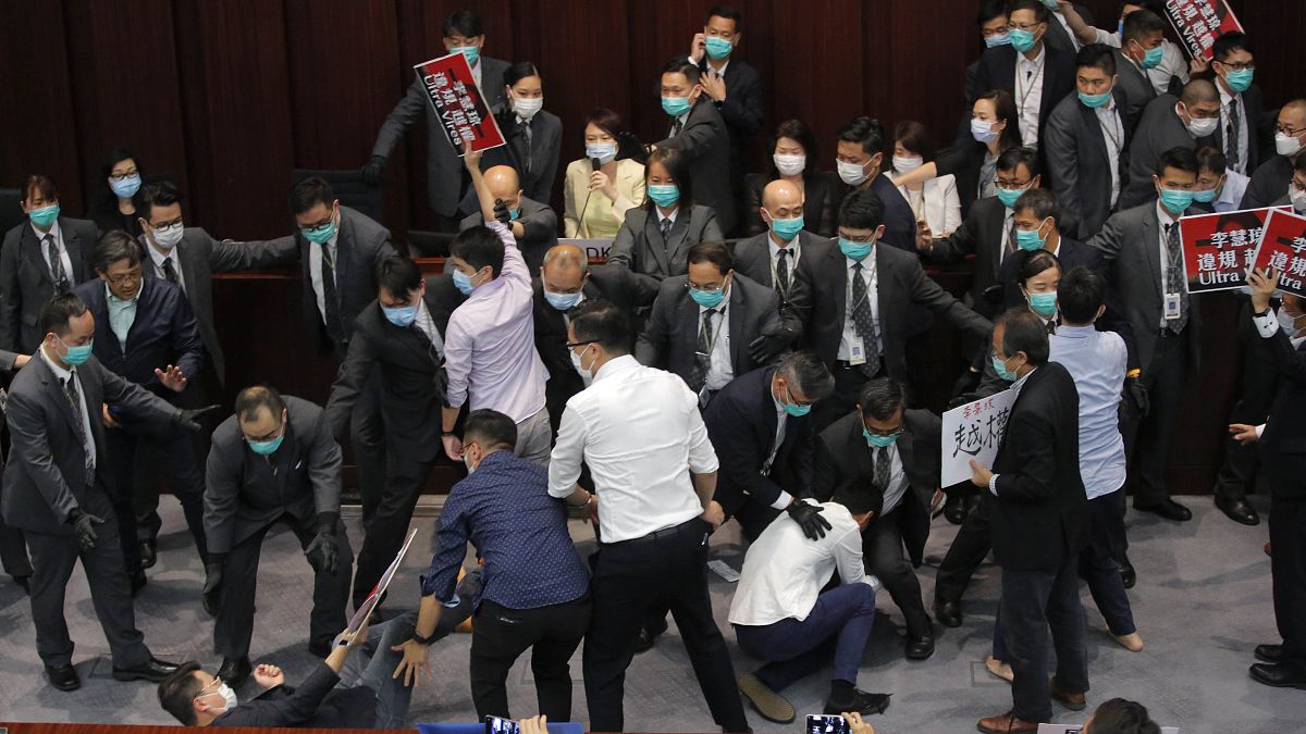 Pro-establishment politician, Starry Lee, center, speaks as pan-democratic legislators scuffle with security guards and pro-China legislators in Hong Kong on May 8, 2020.