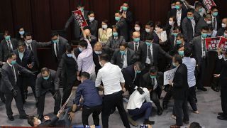 Pro-establishment politician, Starry Lee, center, speaks as pan-democratic legislators scuffle with security guards and pro-China legislators in Hong Kong on May 8, 2020.