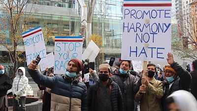 Canadian muslims holding signs