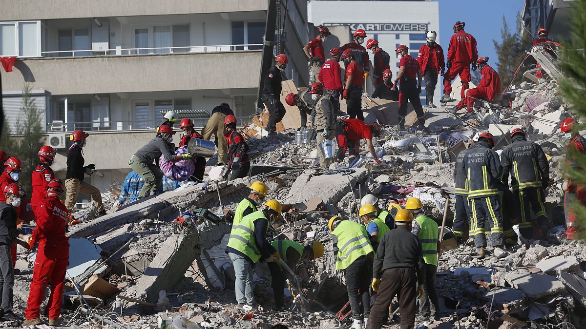 Members of rescue services search for survivors in the debris of a collapsed building in Izmir, Turkey, Saturday, Oct. 31, 2020