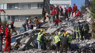 Members of rescue services search for survivors in the debris of a collapsed building in Izmir, Turkey, Saturday, Oct. 31, 2020