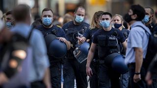 German police officers wear face mask as they walk through the central train station in Frankfurt, Germany, Wednesday, July 22, 2020.