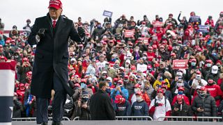 President Donald Trump dances as he walks off stage after speaking during a campaign rally in Washington, Michigan.