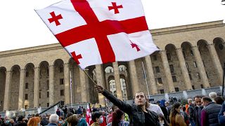 Protesters rally in front of the parliament's building in Tbilisi, Georgia, Sunday, Nov. 1, 2020