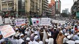 Protesters display placards during an anti-France demonstration in Dhaka