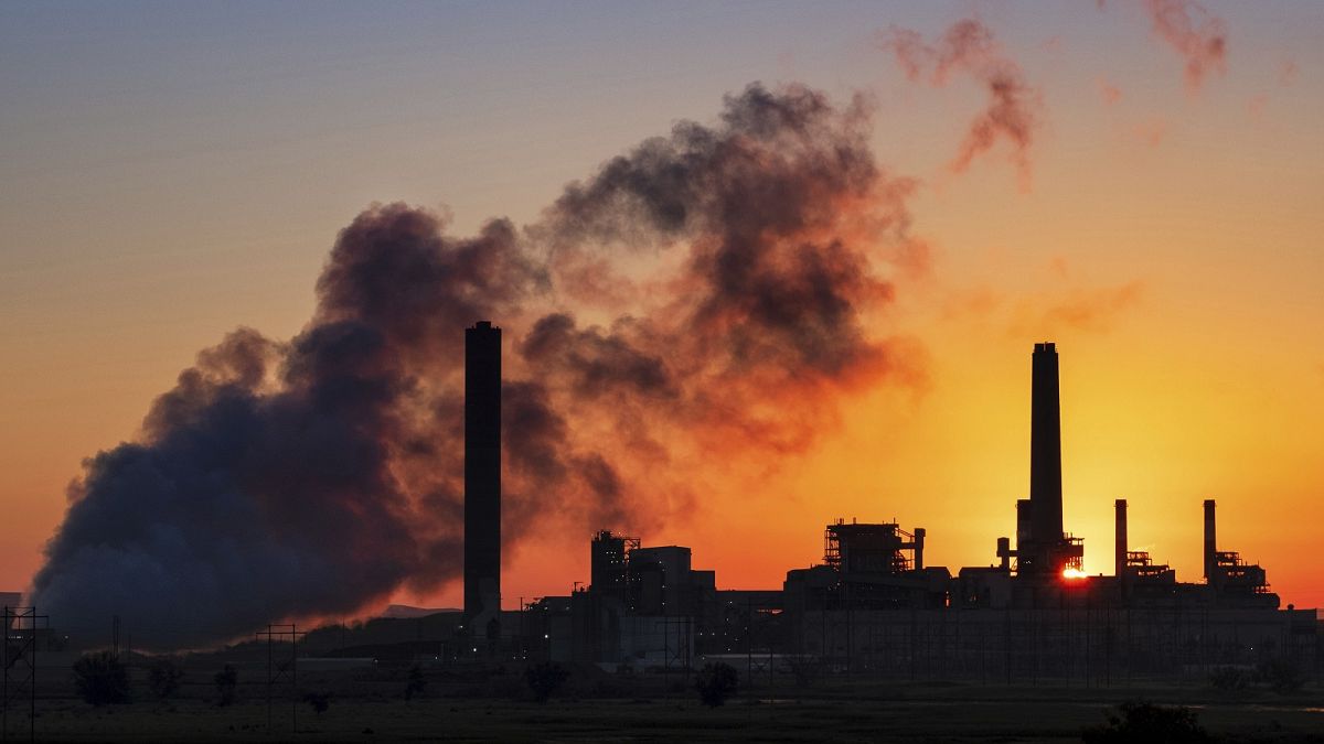 The Dave Johnson coal-fired power plant is silhouetted against the morning sun in Glenrock, Wyoming, USA.