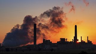 The Dave Johnson coal-fired power plant is silhouetted against the morning sun in Glenrock, Wyoming, USA.