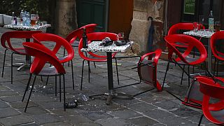 Chairs lie on the ground at the crime scene in a bar in Vienna, Austria, Tuesday, Nov. 3, 2020.