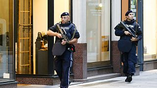 After a shooting armed police officers patrol on a street at the scene in Vienna, Austria, Tuesday, Nov. 3, 2020.