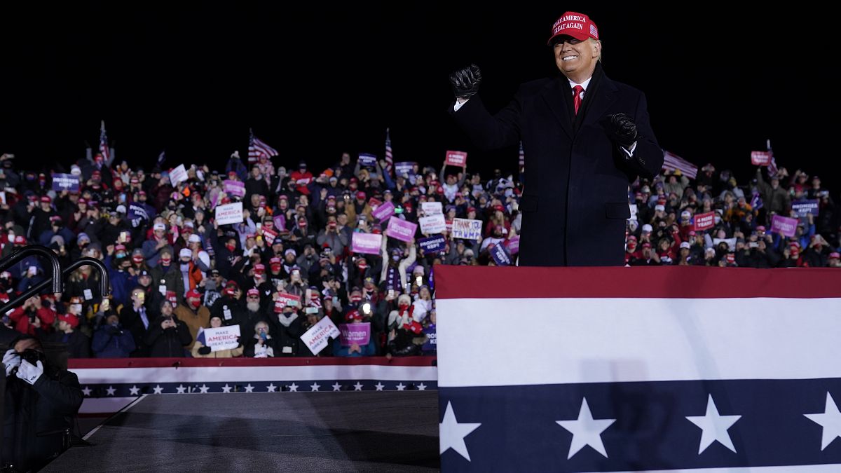 President Donald Trump on stage after a campaign rally at Gerald R. Ford International Airport, early Tuesday, Nov. 3, 2020, in Grand Rapids, Mich. (AP Photo/Evan Vucci)
