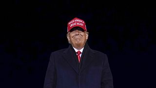 President Donald Trump smiles at supporters after a campaign rally at Gerald R. Ford International Airport in Michigan.