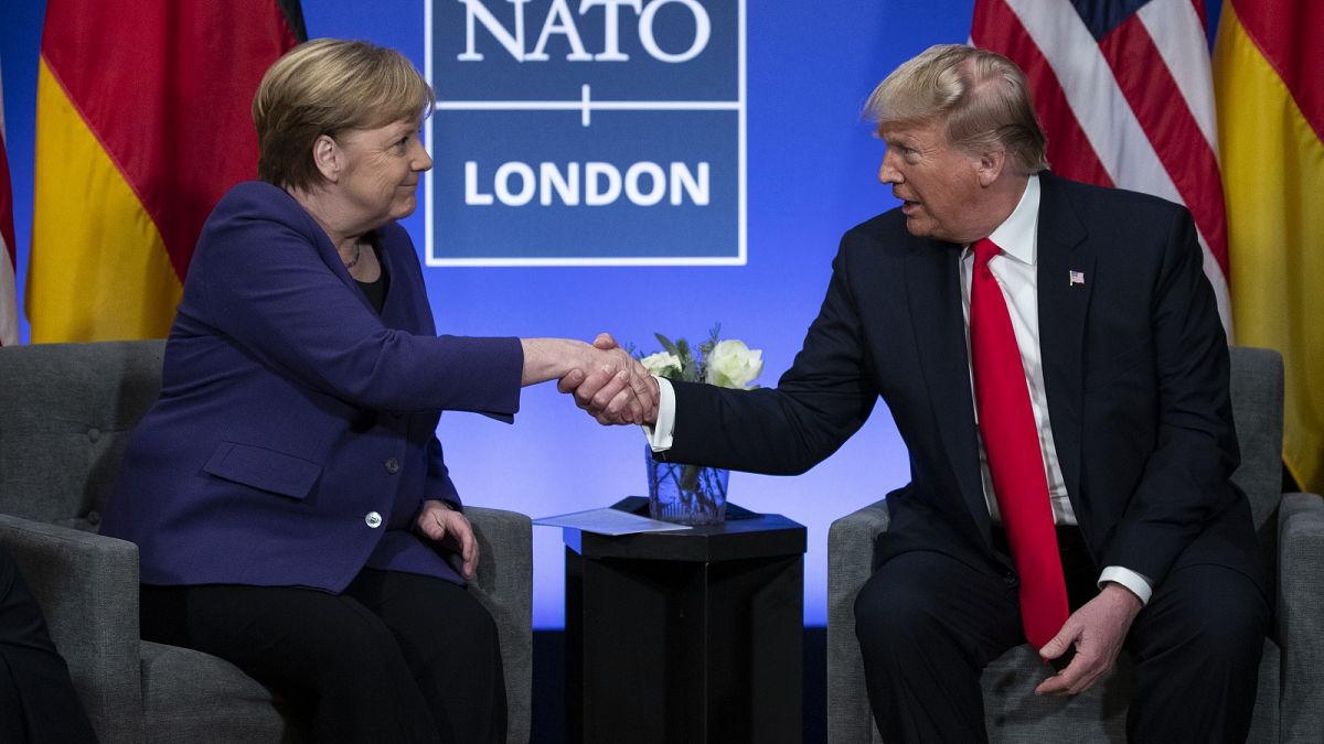 President Donald Trump shakes hands with German Chancellor Angela Merkel during the NATO summit at The Grove in Watford, England, in December 2019.