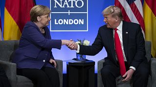 President Donald Trump shakes hands with German Chancellor Angela Merkel during the NATO summit at The Grove in Watford, England, in December 2019.