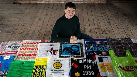 British artist Katrina Cobain poses for photographs with some of her collection of plastic bags.