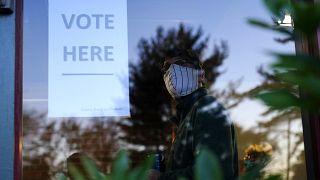 A voter lines up in a polling place to cast a ballot in Springfield, Pennsylvania.