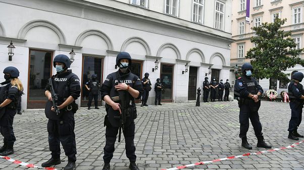 Police stand guard near a crime scene where wreaths have been displayed to pay respects to the victims in the center of Vienna on November 3, 2020, Police stand guard near a crime scene where wreaths have been displayed to pay respects to the victims in the center of Vienna on November 3, 2020,