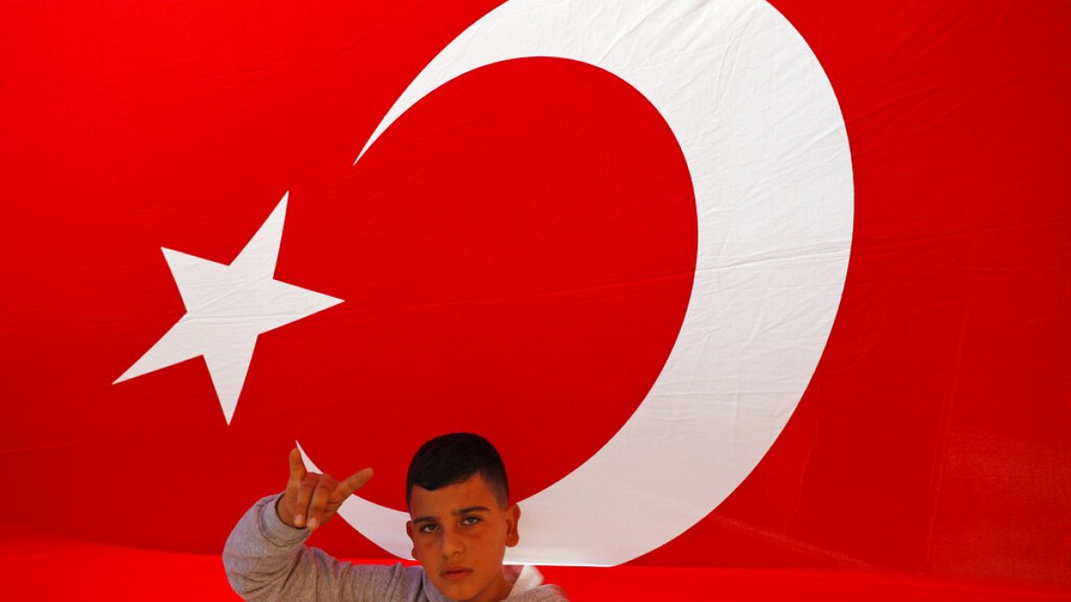 A youth flashes a hand gesture representing the Turkish far-right gray wolves organisation
