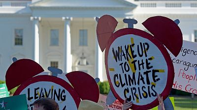 Protesters gather outside the White House in Washington, 2017, to protest President Donald Trump's decision to withdraw the Unites States from the Paris Agreement. Protesters gather outside the White House in Washington, 2017, to protest President Donald Trump's decision to withdraw the Unites States from the Paris Agreement.