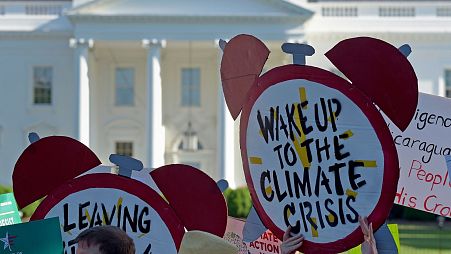 Protesters gather outside the White House in Washington, 2017, to protest President Donald Trump's decision to withdraw the Unites States from the Paris Agreement.