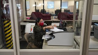 A county election worker scans ballots at a tabulating area at the Clark County Election Department, Wednesday, Nov. 4, 2020, in Las Vegas.