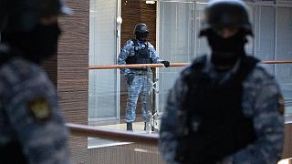 Security officers standing guard at the Alexei Navalny's Foundation for Fighting Corruption office in Moscow, Russia, Thursday, Nov. 5, 2020. 