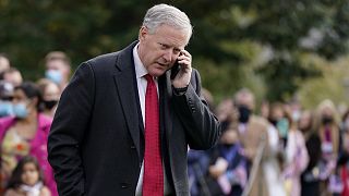White House chief of staff Mark Meadows speaks on a phone on the South Lawn of the White House.