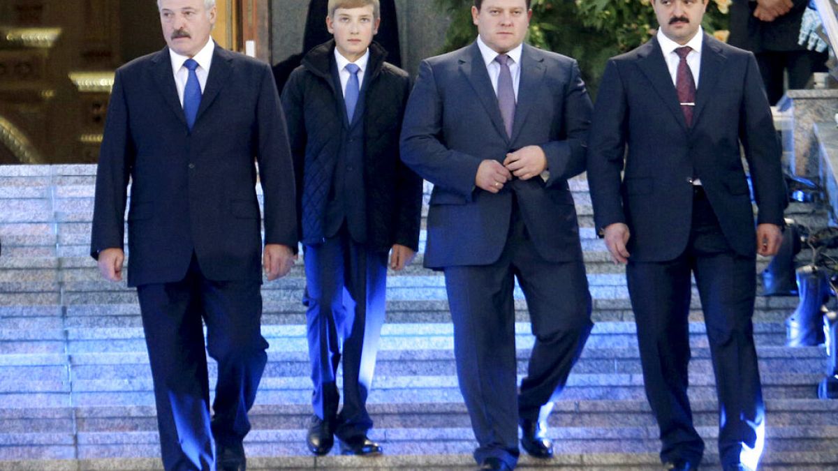 In this photo taken Friday, Oct. 2, 2015, Belarusian President Alexander Lukashenko, left, with his sons, from right, Viktor, Dmitry and Nikolai, walk after a church service.