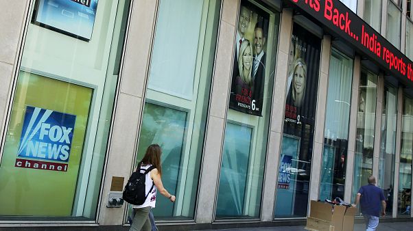 People pass the News Corporation headquarters building and Fox News studios in New York on Aug. 1, 2017. People pass the News Corporation headquarters building and Fox News studios in New York on Aug. 1, 2017.