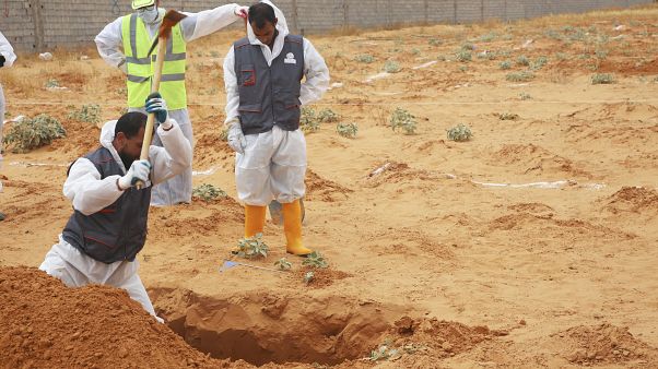 Libyan Ministry of justice employees dig out at a siyte of a suspected mass grave in the town of Tarhouna, Libya, Tuesday, June 23, 2020. Libyan Ministry of justice employees dig out at a siyte of a suspected mass grave in the town of Tarhouna, Libya, Tuesday, June 23, 2020.