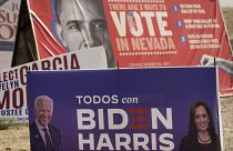A campaign sign supporting Democratic presidential candidate Joe Biden and running mate Kamala Harris stands in front of a vote sign showing former President Obama.