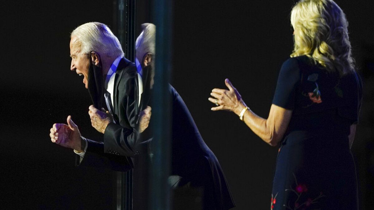 President-elect Joe Biden reacts on stage with Jill Biden after speaking, Nov. 7, 2020, in Wilmington, Del.