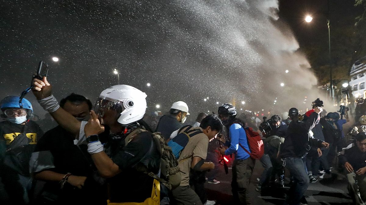 Police use water cannons to disperse pro-democracy protesters during a street march in Bangkok, Thailand Sunday, Nov. 8, 2020. 