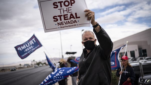 Supporters of President Donald Trump hold signs as they stand outside of the Clark County Elections Department in North Las Vegas, Nev. Saturday, Nov. 7, 2020. Supporters of President Donald Trump hold signs as they stand outside of the Clark County Elections Department in North Las Vegas, Nev. Saturday, Nov. 7, 2020.