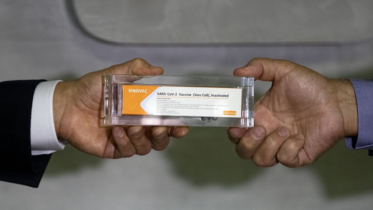 Sao Paulo Governor Joao Doria, left, and Butantan Institute Director Dimas Covas show a box of an experimental COVID-19 vaccine. Sao Paulo, Brazil, Monday, Nov. 9, 2020.