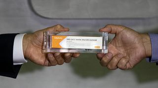 Sao Paulo Governor Joao Doria, left, and Butantan Institute Director Dimas Covas show a box of an experimental COVID-19 vaccine. Sao Paulo, Brazil, Monday, Nov. 9, 2020.